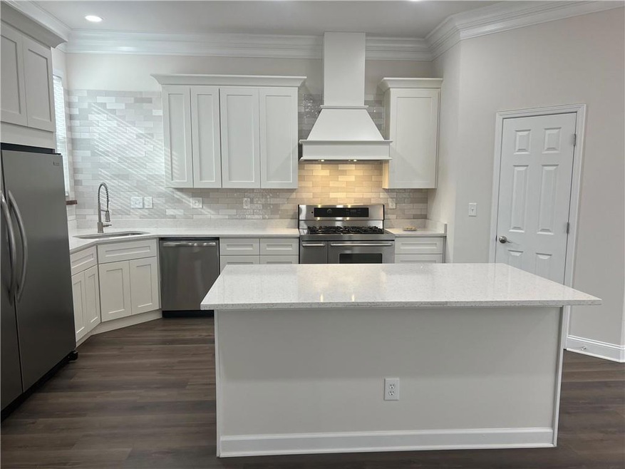 Kitchen featuring a sink, dark wood finished floor