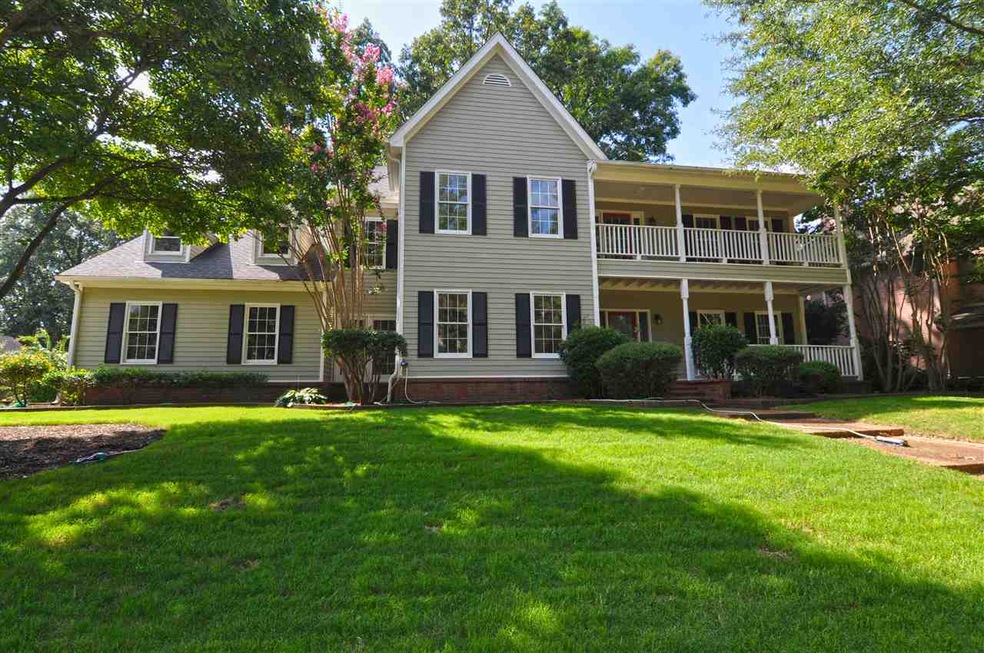 A large country porch accented with beautiful lush