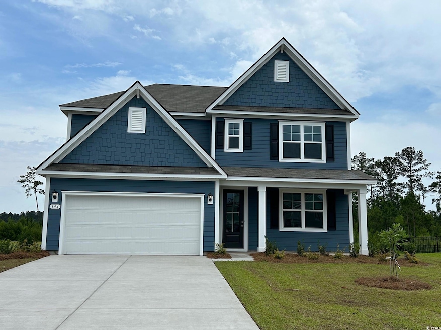 Craftsman-style home with driveway, a front yard, an attached garage, and covered porch
