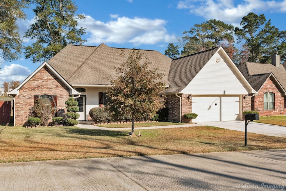 View of front property with a front yard and a gar