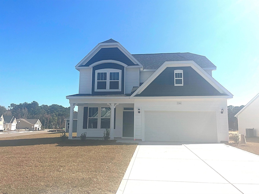 View of front of property with covered porch, concrete driveway, and a garage