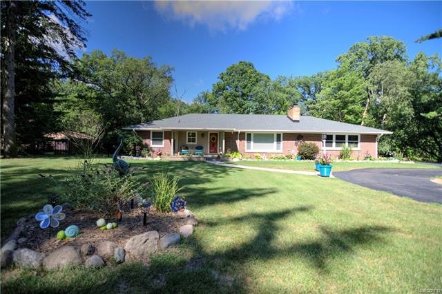 Beautiful entrance to home front lined with trees 