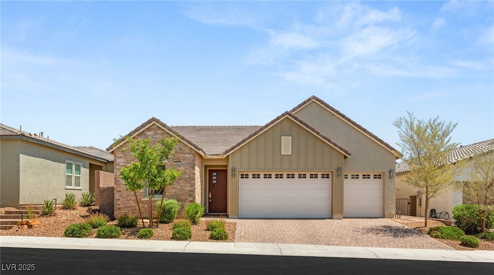 Single story home featuring decorative driveway, a