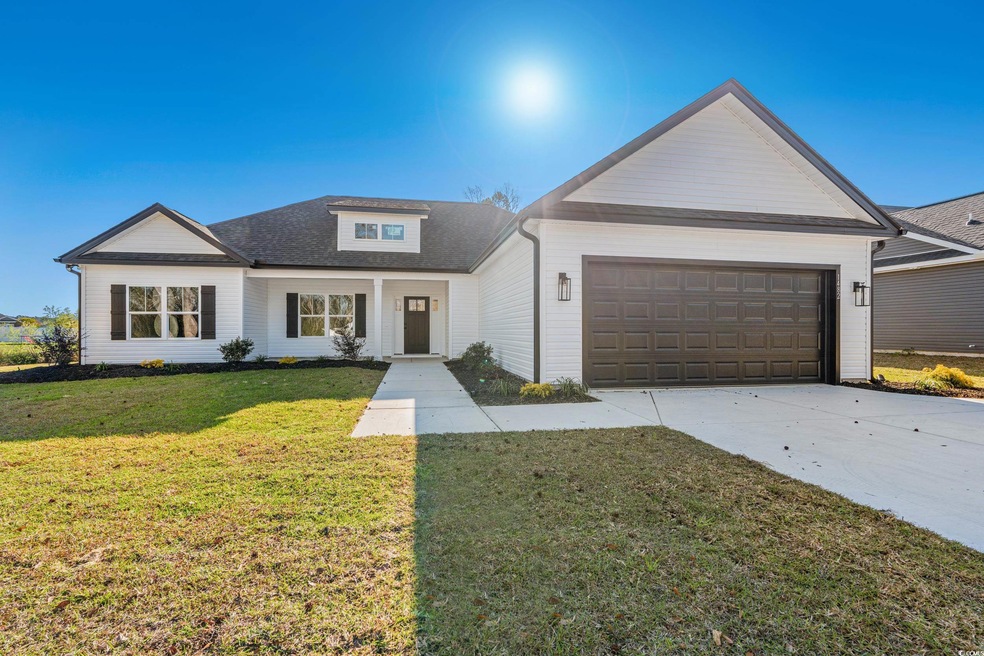 Modern farmhouse with concrete driveway, an attach