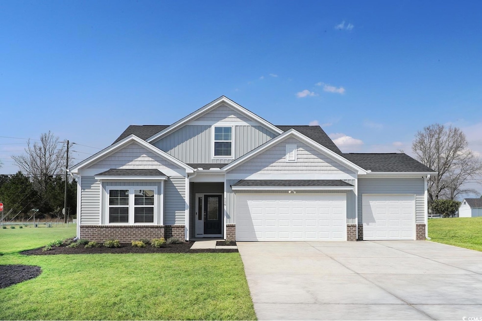 Craftsman-style home with driveway, a front yard, an attached garage, and brick siding