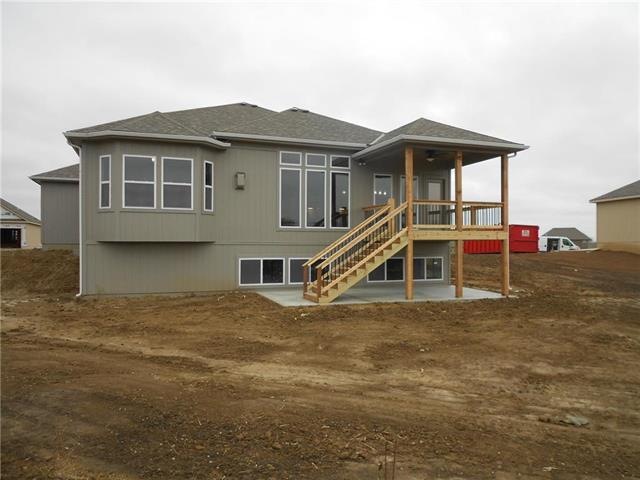 Back of home with covered deck and patio