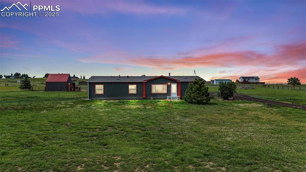 Rear view of property with an outbuilding and a view of rural / pastoral area