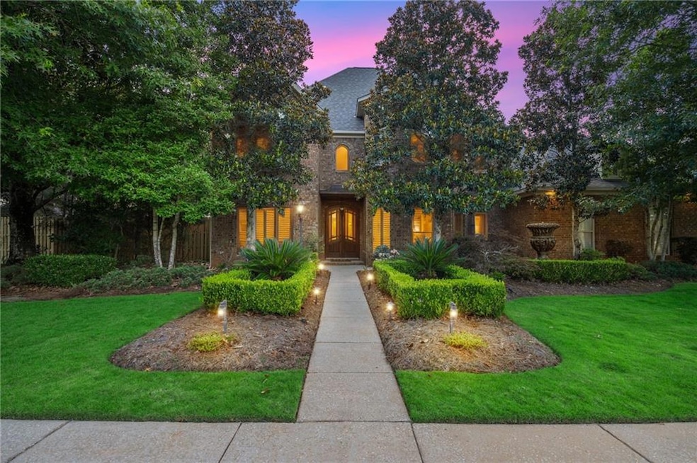View of front of property featuring a lawn and brick siding