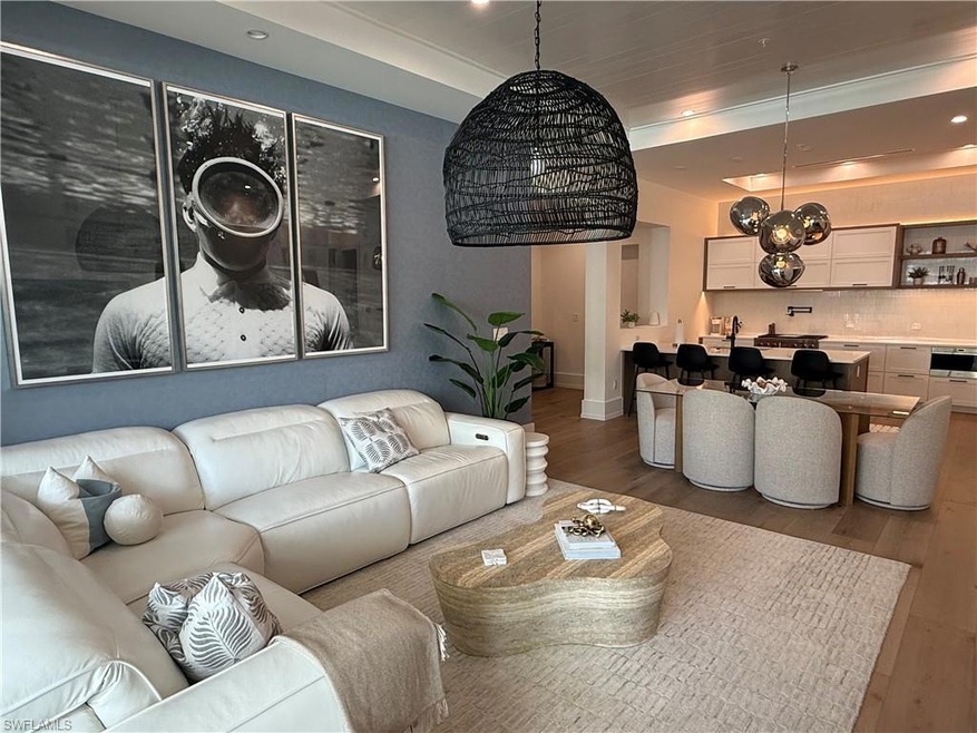 Living room with wood finished floors, baseboards, and recessed lighting