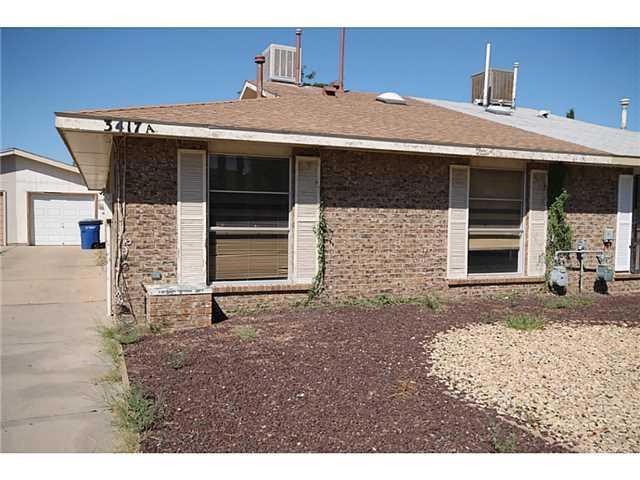 Exterior Front. Rock landscaping. house