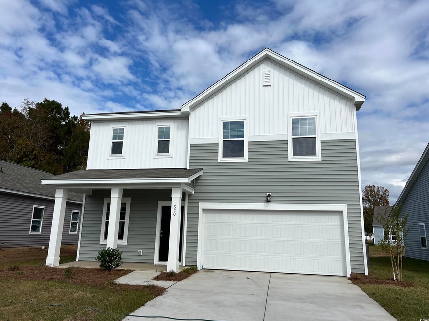 View of front of house with covered porch and a ga