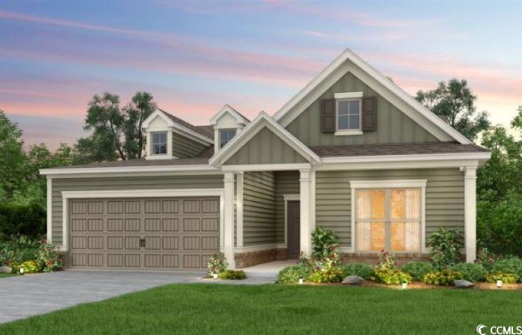 View of front facade with a garage and a lawn