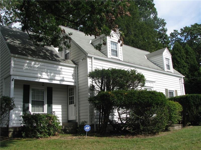 This 1 1/2 story Cape Cod is located on a private 