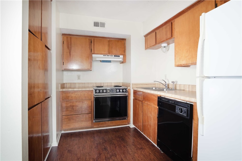 Kitchen featuring freestanding refrigerator, black