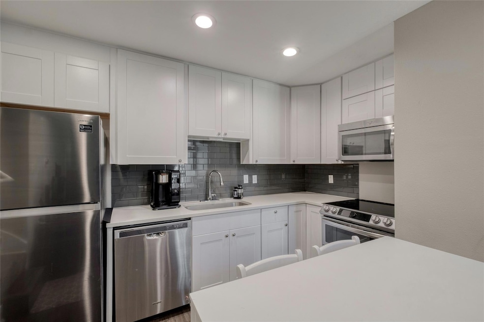 Kitchen with decorative backsplash, light counter
