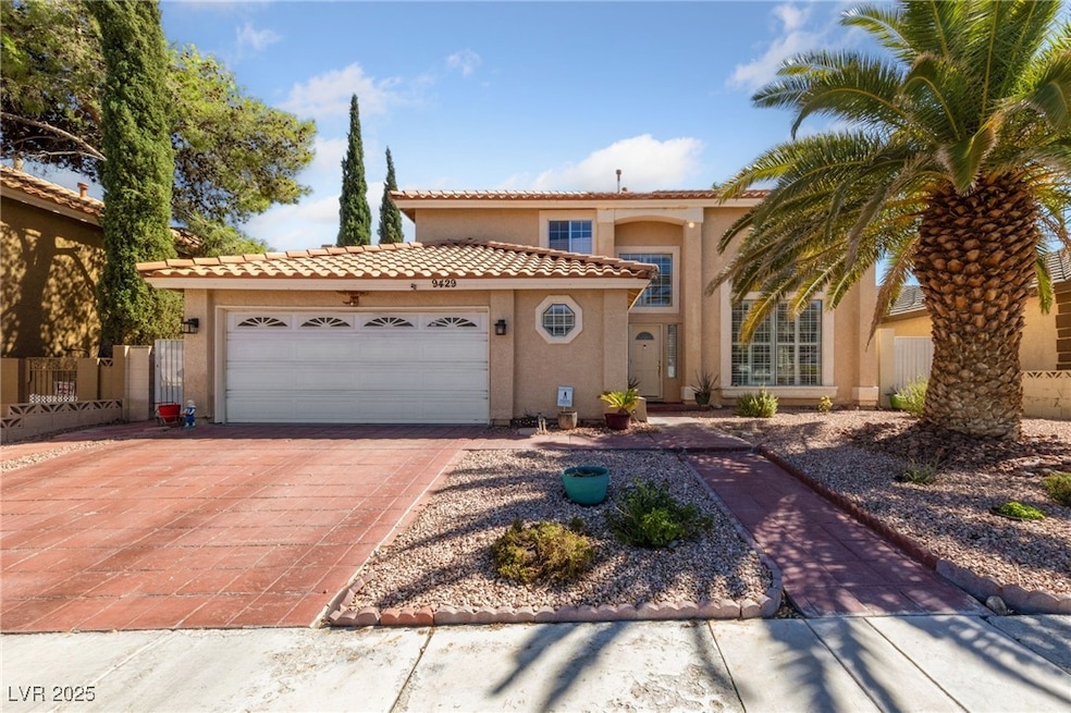 Mediterranean / spanish home featuring an attached garage, stucco siding, decorative driveway, and a tiled roof