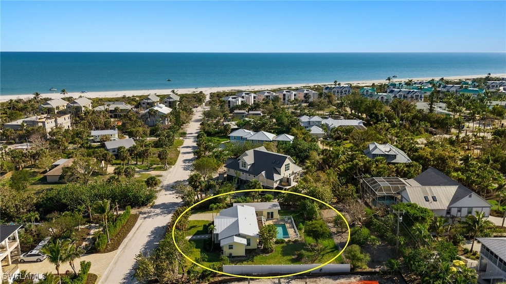 Birds eye view of property with a view of the beac