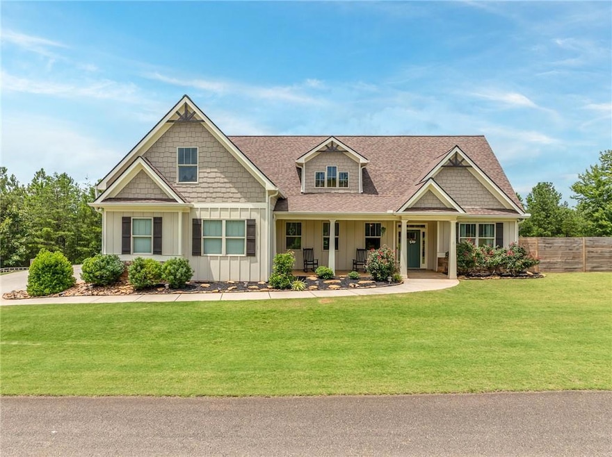 Craftsman house featuring board and batten siding, a porch, and a shingled roof