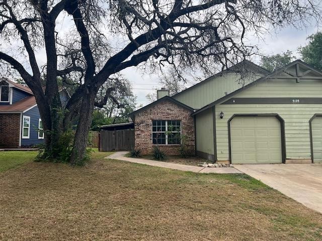 View of front of house with a chimney, a garage, 