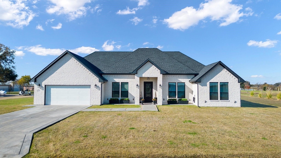 View of front of property featuring a garage and a