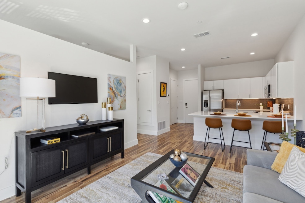 Living area with recessed lighting and light wood-type flooring