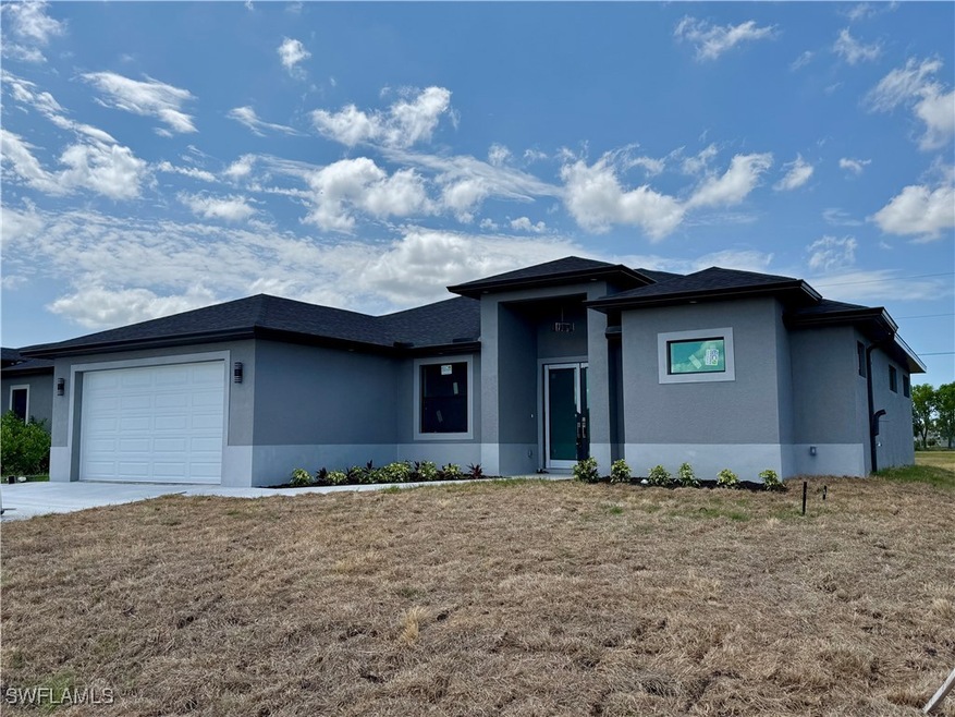 Prairie-style home featuring stucco siding, an att