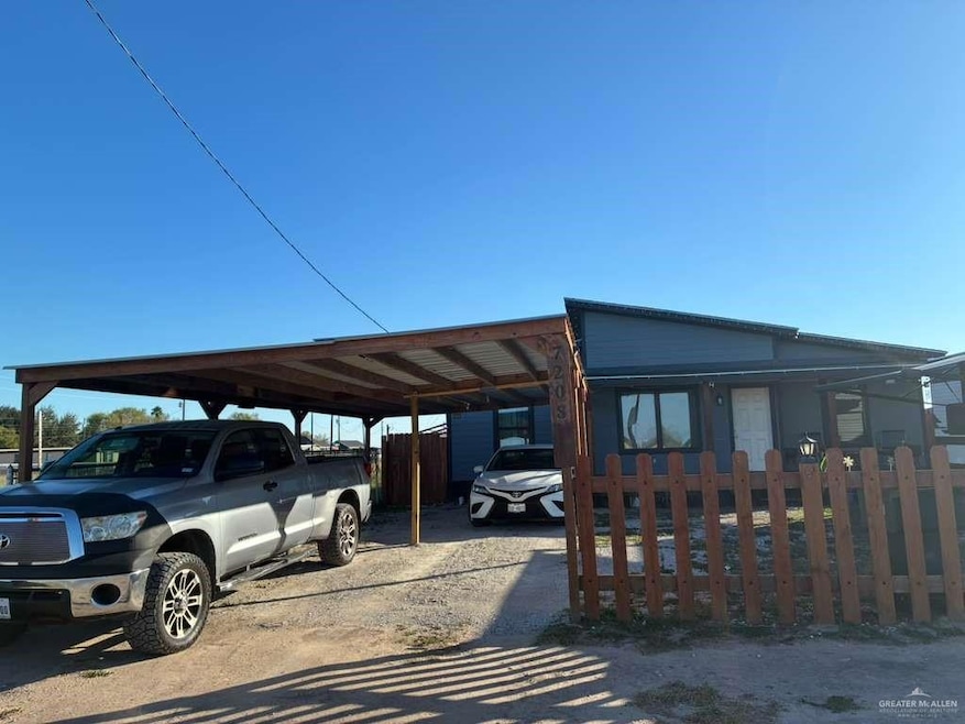 View of front of property featuring an attached carport and driveway