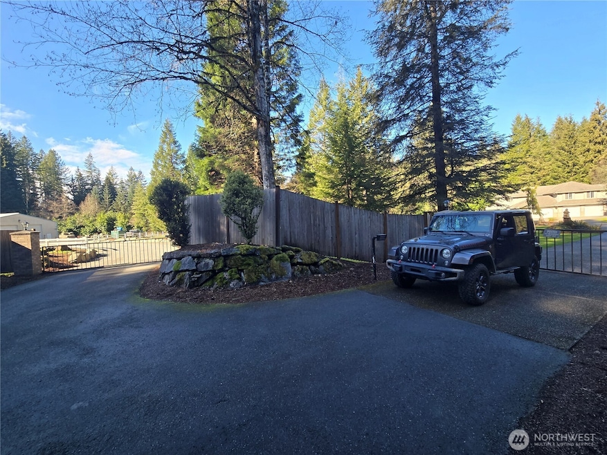 2 Main entry gated entries - the one on the left being for the detached  shop, the one on the right for the home.  a 3rd gated/service entry is to the rear of the home.