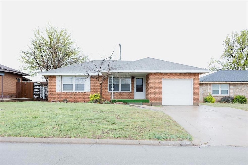 Ranch-style house featuring brick siding, a front 