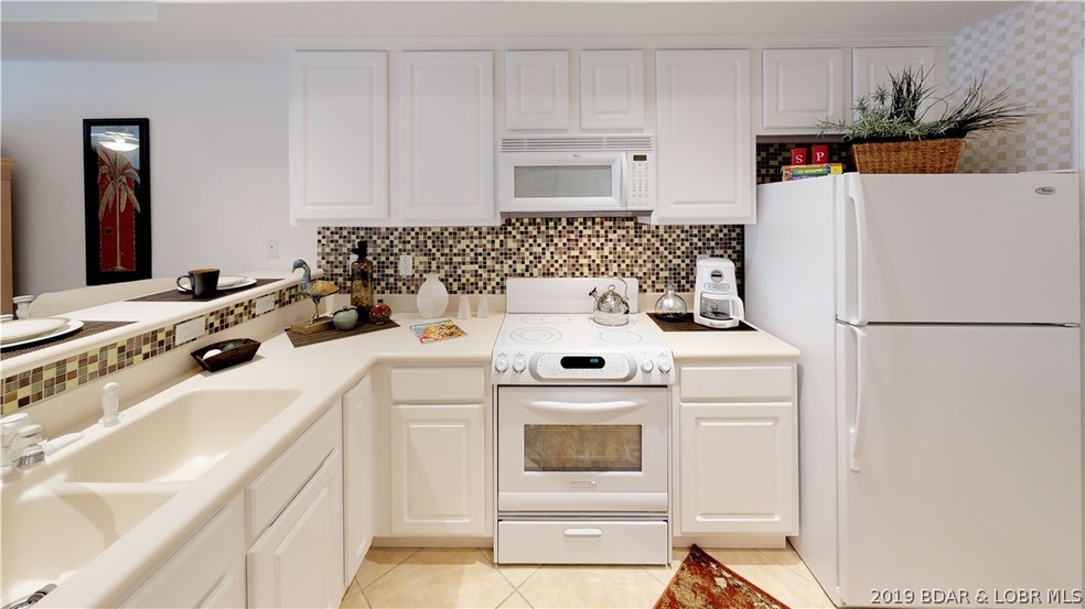 Large light bright kitchen with solid surface coun