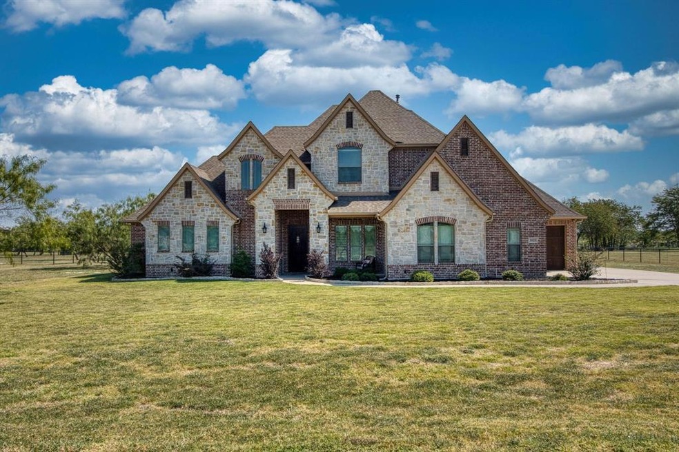 Peek inside this GORGEOUSE home with stone accents and beautifully landscaped curb appeal!