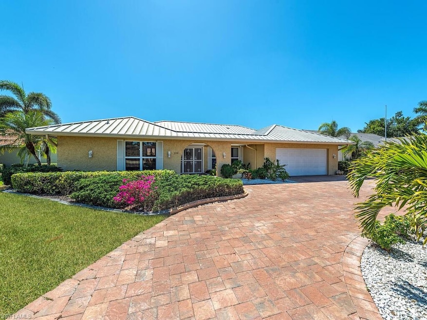 Single story home with decorative driveway, a fron