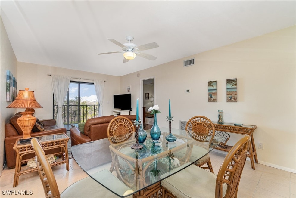 Dining area featuring ceiling fan and light tile p