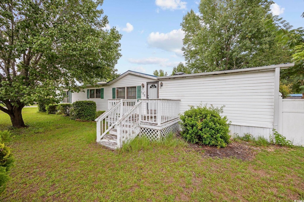 Rear view of property with a yard and a deck