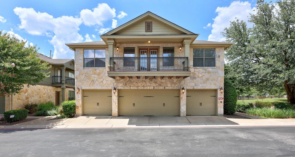 View of front of home with stone siding, a garage