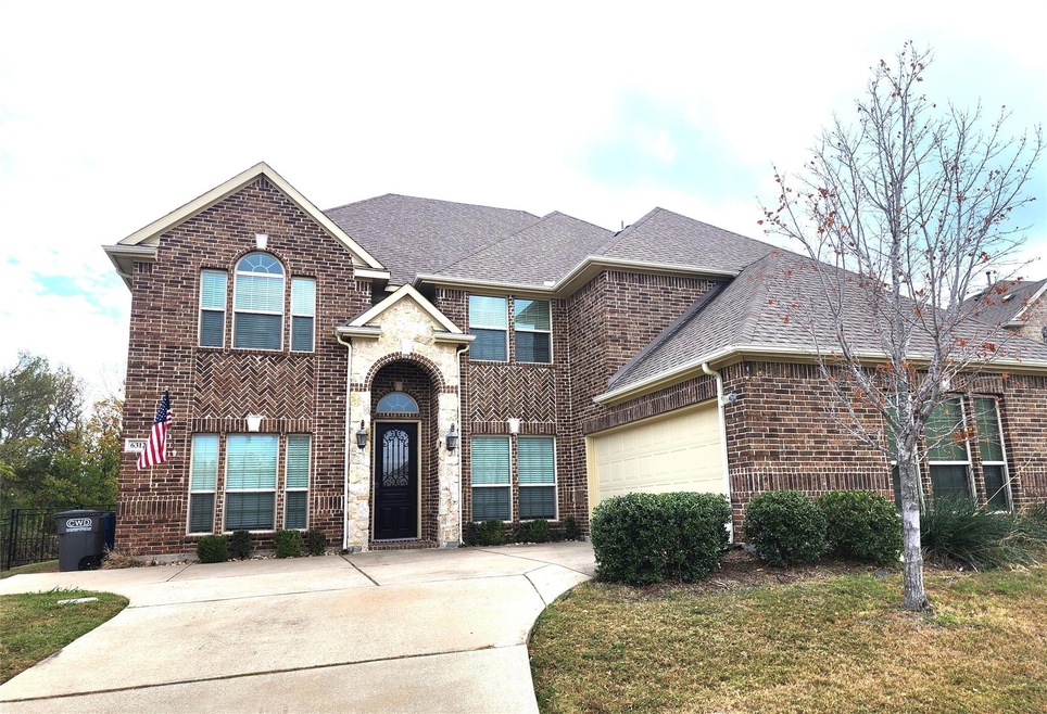 View of front of house with a front yard and a garage