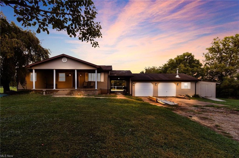 Single story home featuring garage and a lawn