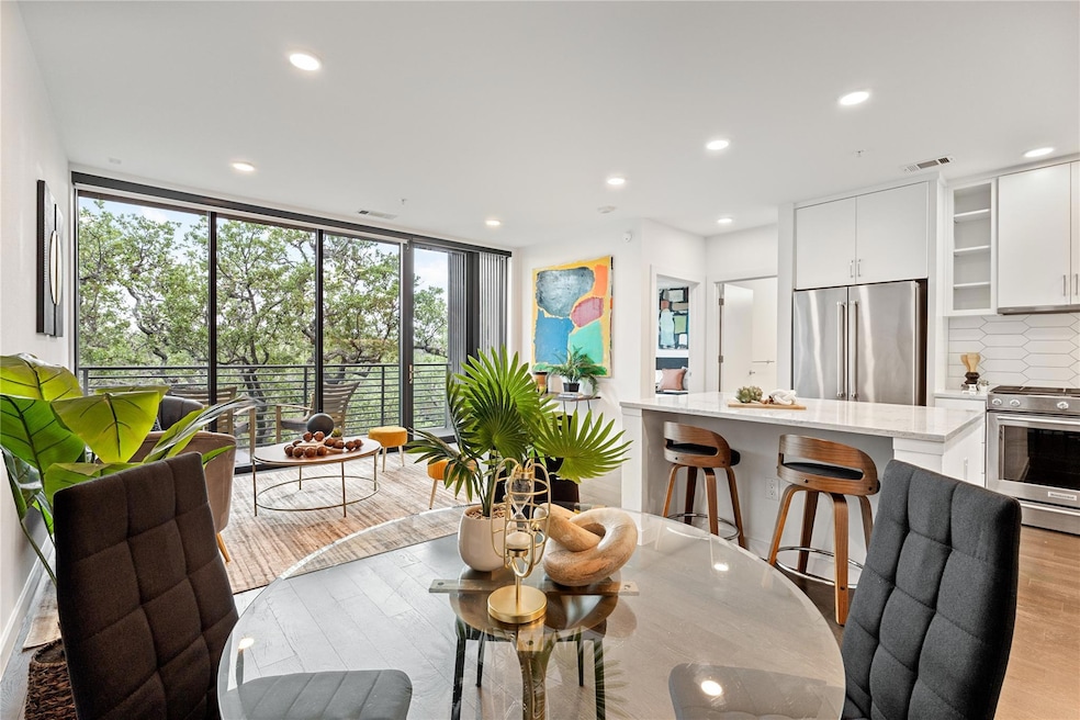 Dining room with recessed lighting, light wood fi