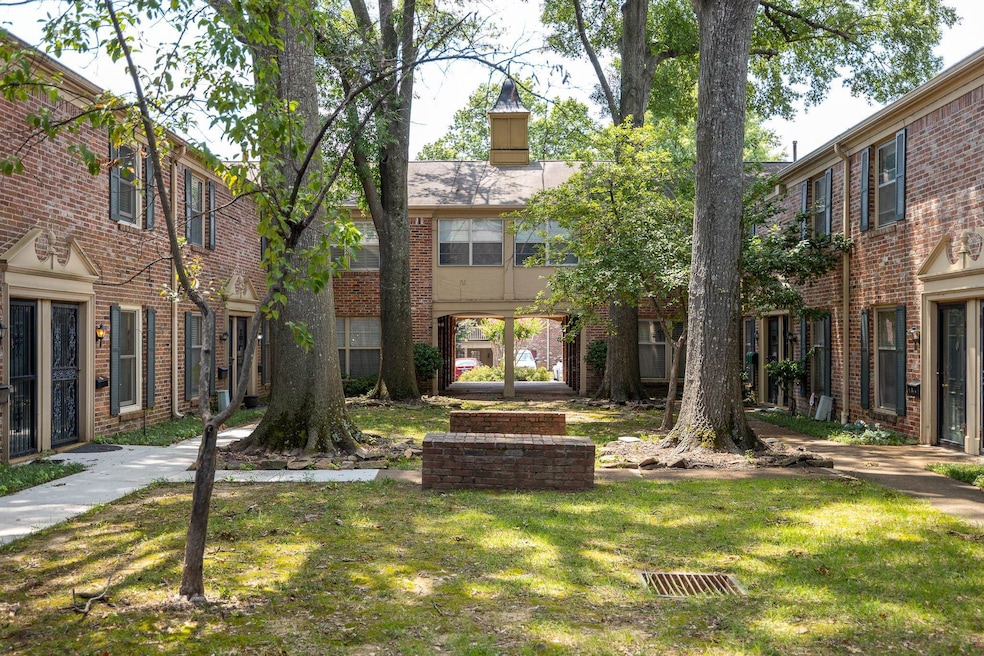 View of front facade featuring a front lawn and brick siding