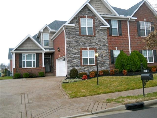 Sitting Pretty on a corner lot! Custom stone & brick is only one of the many upgrades!