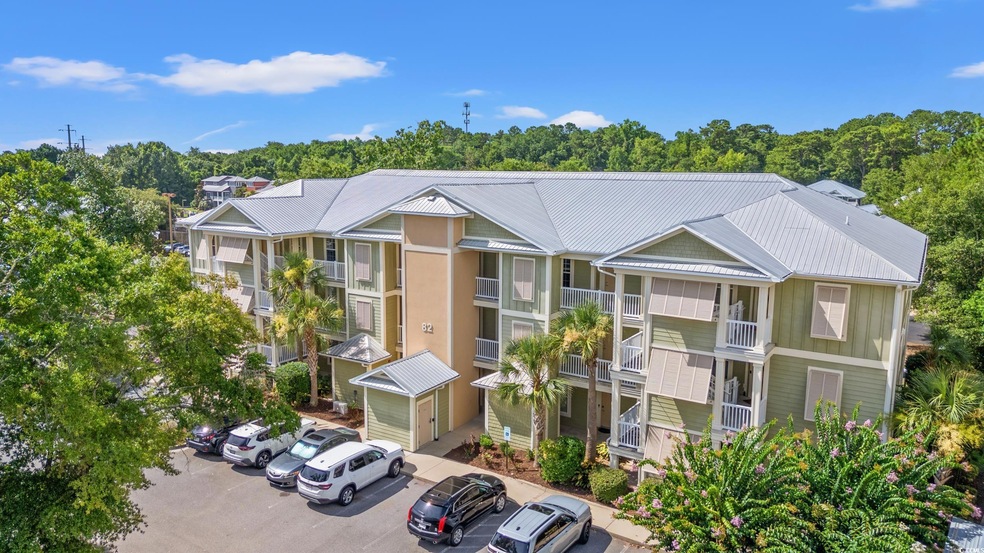View of building exterior with uncovered parking