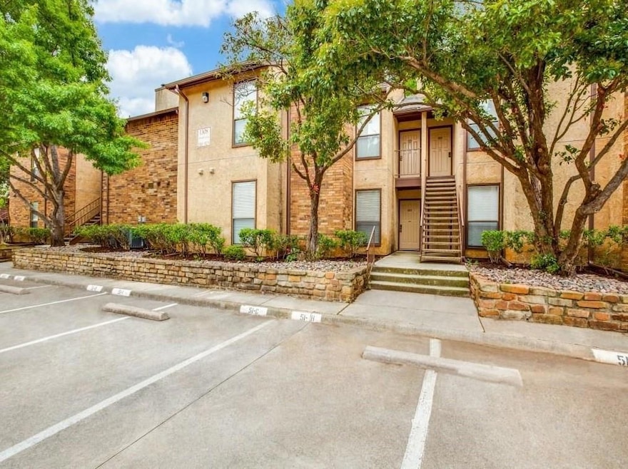 View of property featuring uncovered parking and s