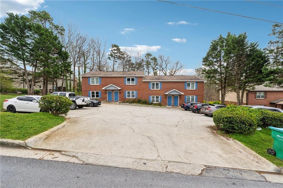 View of front of house with brick siding and uncov
