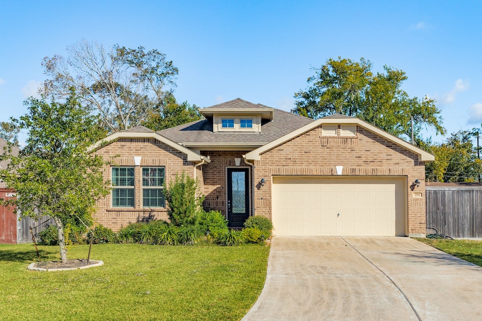 Charming single-story brick home with a convenient two-car garage and well-maintained lawn offering great curb appeal.