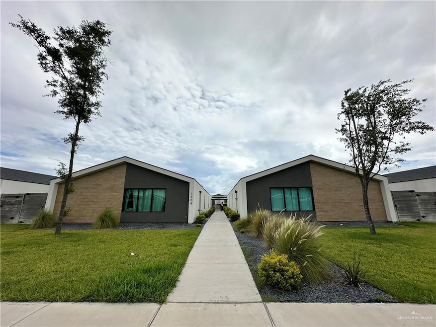 Mid-century inspired home featuring a front lawn, stucco siding, and brick siding