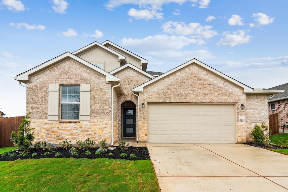 View of front of house with stone siding, a garag