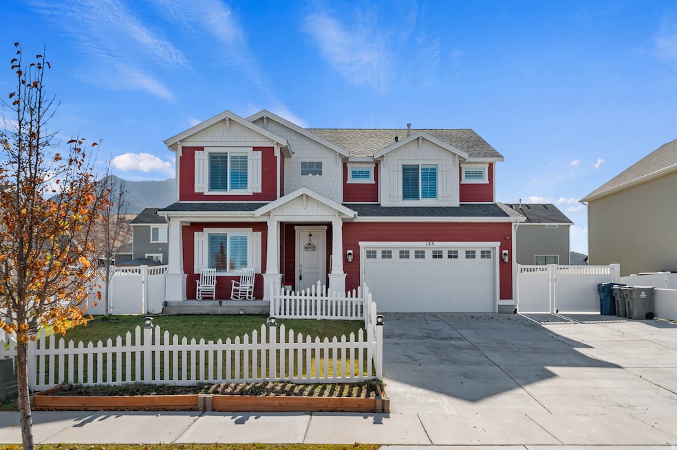 Craftsman-style house featuring driveway, a garage, a fenced front yard, a gate, and roof with shingles