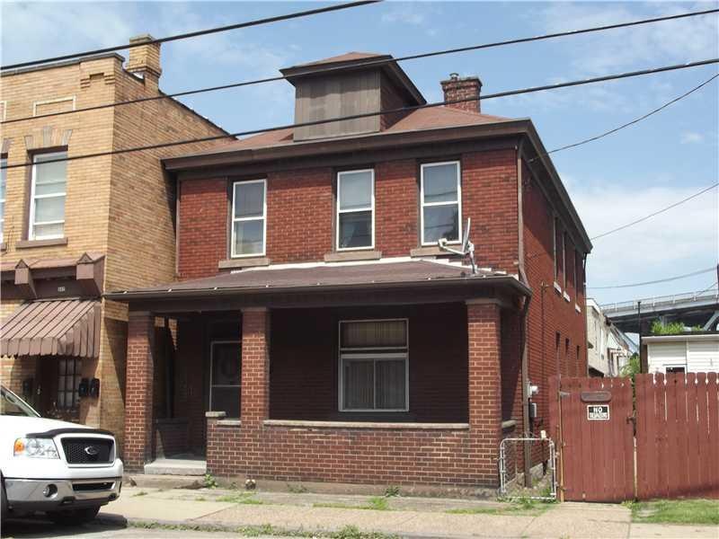Exterior Front. Large, all brick exterior, fenced 