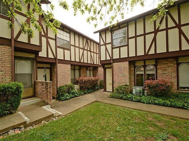 Rear view of house featuring brick siding