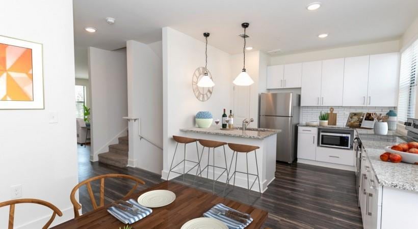 Kitchen with a breakfast bar area, white cabinets,